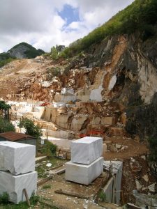 A working marble quarry in the Apuan Alps above Carrara, white cut faces stepped into the mountain