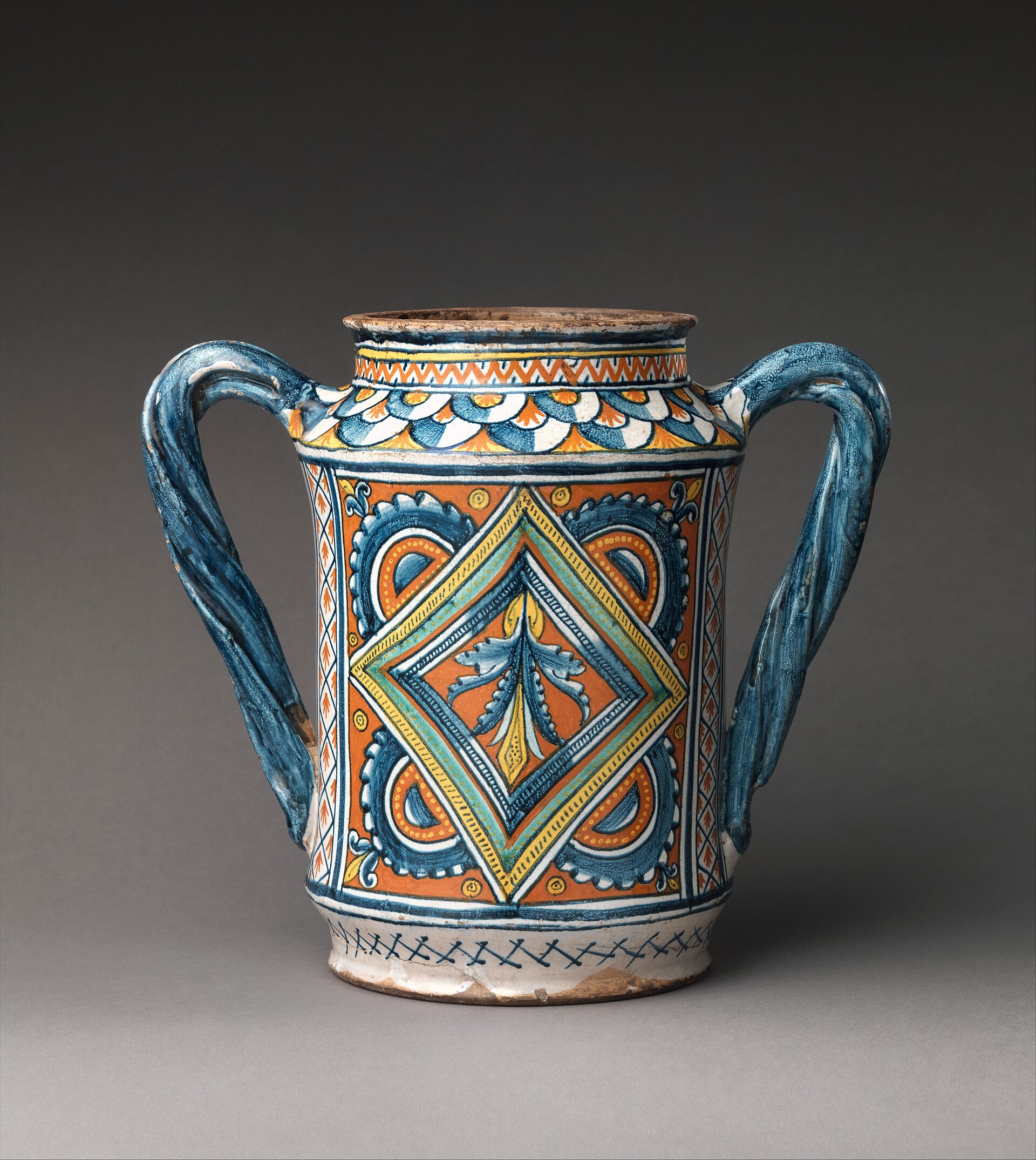 A tin-glazed maiolica albarello, or drug jar, decorated in blue on a white ground
