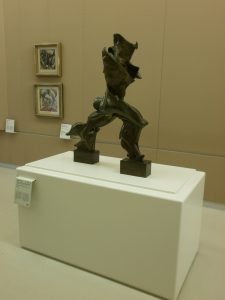 Bronze sculpture of a striding figure with flame-like flared forms, by Umberto Boccioni
