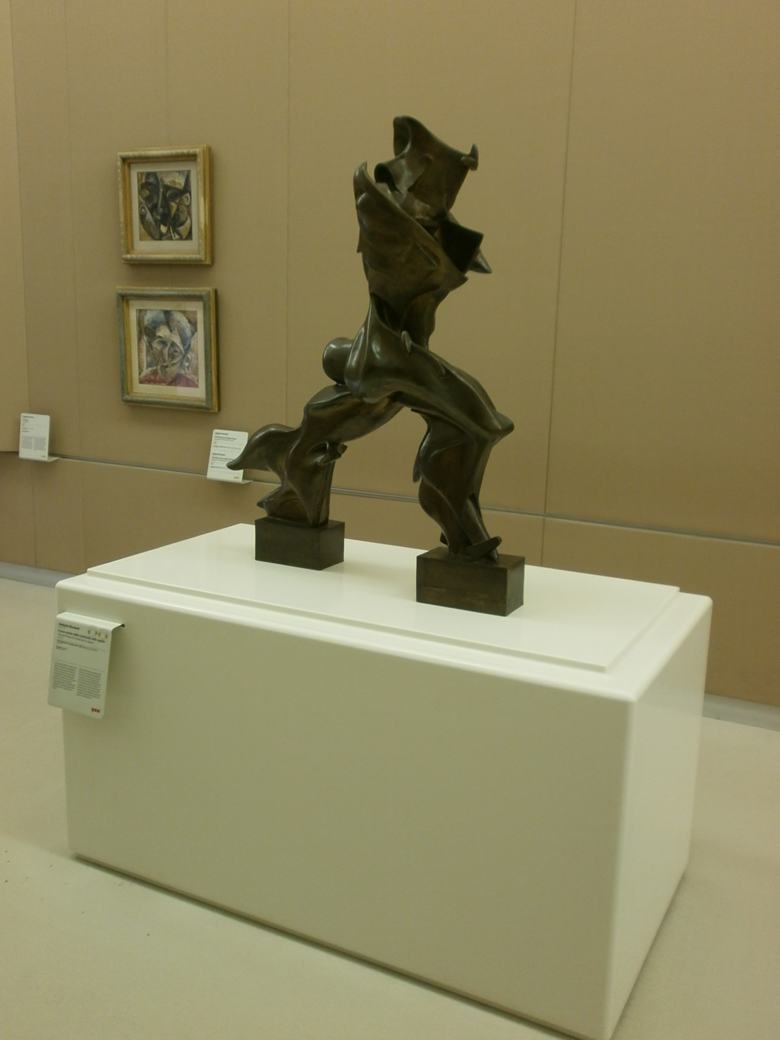 Bronze sculpture of a striding figure with flame-like flared forms, by Umberto Boccioni