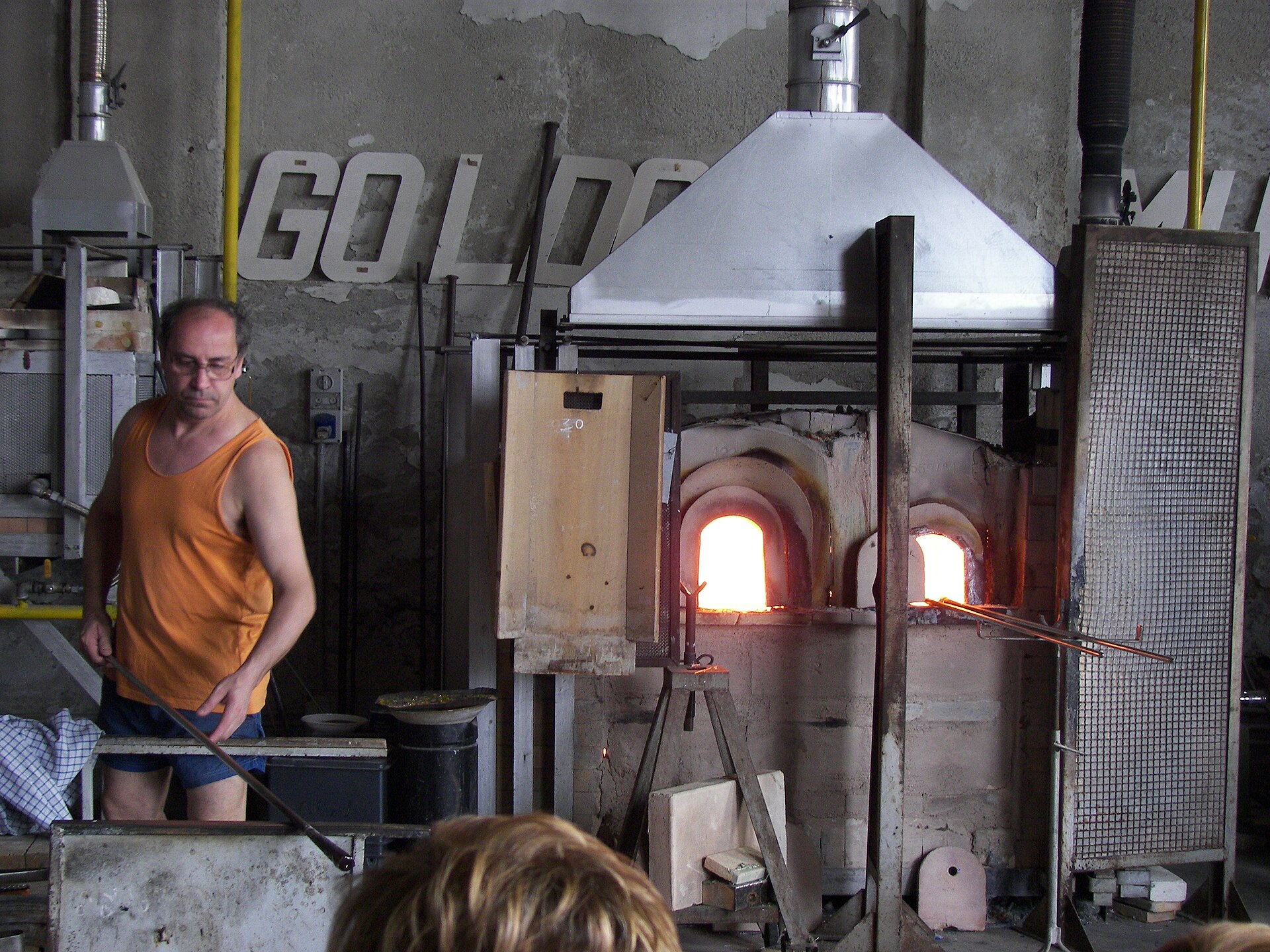 A glassmaker's furnace on Murano, the glowing mouth of the crucible visible